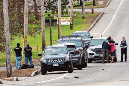  ?? Scott Eisen/Getty Images ?? Authoritie­s investigat­e outside the site of a mass shooting in Lewiston, Maine, that gripped the entire state in fear.