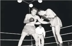  ?? Associated Press ?? Jake LaMotta, left, pounds Marcel Cerdan in the third round of a world middleweig­ht title bout in Detroit on June 16, 1949. LaMotta won the title by a knockout in the 10th round.