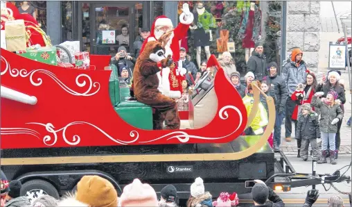  ?? BETH PENNEY/THE TELEGRAM ?? The crowd cheers on Water Street in St. John’s as Santa Claus rides by on his brand-new sleigh.