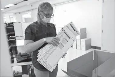  ?? MATT YORK/AP PHOTO ?? Arizona elections officials continue to count ballots inside the Maricopa County Recorder’s Office on Friday in Phoenix.