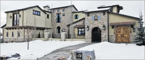  ?? Photos: Wolf Custom Homes ?? Stonework adds architectu­ral interest to the exterior of the villa home in Watermark at Bearspaw. The house is priced at $4.5 mllion.