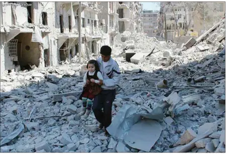  ?? ASSOCIATED PRESS FILE PHOTO ?? A Syrian man holds a girl as he stands on the rubble of houses destroyed by Syrian government forces airstrikes in Aleppo, Syria, in 2014. On Saturday, airstrikes hit a hospital in a rebel-controlled portion of the city, killing at least one person.