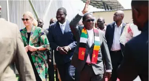  ?? ?? President Mnangagwa greets PHD Ministries followers while escorted by Sports, Recreation, Arts and Culture Minister Kirsty Coventry (left) and PHD leader Prophet Walter Magaya at the commission­ing of The Heart Stadium in Harare yesterday