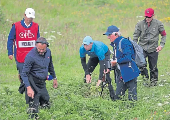  ?? Picture: Shuttersto­ck. ?? A posse help Rory McIlroy look for his opening tee shot at the Open at Royal Portrush.