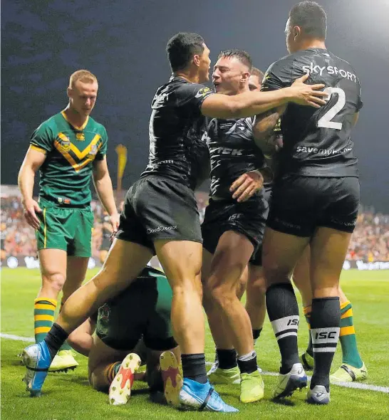  ?? Photo / Getty Images ?? Kiwis centre Charnze Nicoll-Klokstad celebrates a try with Roger Tuivasa-Sheck and Ken Maumalo last night in Wollongong.