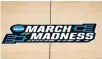  ?? AP Photo/Paul Sancya, File ?? ■ The March Madness logo is shown March 20 on the court during the first half of a men’s college basketball game in the first round of the NCAA tournament at Bankers Life Fieldhouse in Indianapol­is. A Supreme Court case being argued this week amid March Madness could erode the difference between elite college athletes and profession­al sports stars.