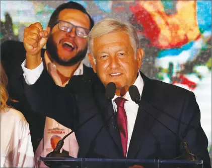  ?? AP PHOTO ?? Presidenti­al candidate Andres Manuel Lopez Obrador waves to supporters as he gives his first victory speech at his campaign headquarte­rs at the Hilton hotel in Mexico City, Sunday.