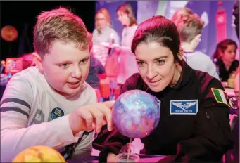  ??  ?? County Mayo Astronaut Norah Patten, exploring some model planets with Charlie Clay (10) at the annual Science Fair with AbbVie as part of Science Week Ireland, in the Institute of Technology, Sligo.