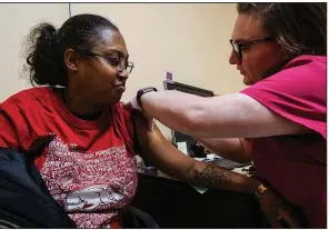  ?? Arkansas Democrat-Gazette/MITCHELL PE MASILUN ?? Amanda Butler of Little Rock gets her flu shot from nurse coordinato­r Miranda Tucker at the Pulaski County unit of the state Health Department in Little Rock.