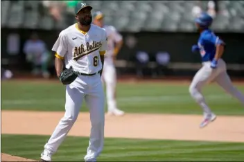  ?? AP Photo/Tony Avelar ?? Oakland Athletics relief pitcher Reymin Guduan (61) stands on the edge of the mound as Toronto Blue Jays’ Marcus Semien, right, runs the bases after hitting a solo home run during the seventh inning of a baseball game in Oakland, Calif., on Wednesday.