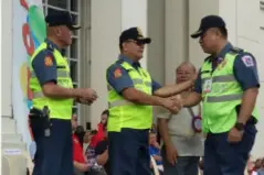  ?? GLAZYL MASCULINO ?? SENIOR Superinten­dent Francisco Ebreo, acting director of Bacolod City Police Office (BCPO), shakes hand with Chief Superinten­dent Carlito Feliciano, deputy regional director for administra­tion of Police Regional Office (PRO)-6, after receiving the Philippine National Police (PNP) Merit Medal. Also in photo are Senior Superinten­dent Remus Canieso (left), chief directoria­l staff of PRO-6, and City Administra­tor John Orola, during the sendoff of troops for Masskara Festival and awarding rites held at the Government Center Monday.