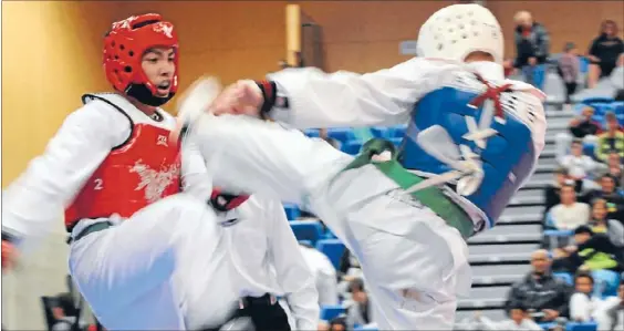  ?? Photo: ANDREA O’NEIL ?? Leg work: Tawa green belt Adrian Alcance, in red, 18, beat Tertius Jacobs, 23, of Titahi Bay, 19-17 in an under-63kg taekwondo bout at Te Rauparaha Arena.