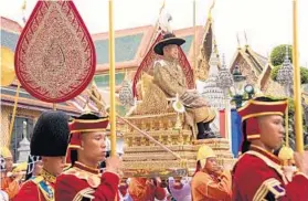  ?? THAI ROYAL HOUSEHOLD BUREAU ?? A throne of his own: Thailand’s King Maha Vajiralong­korn was officially crowned Saturday amid the splendor of the country’s Grand Palace in Bangkok, taking the central role in an elaborate royal ceremony last held almost seven decades ago.