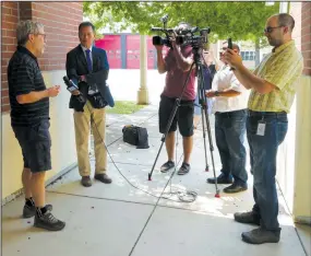  ?? CYNDY GREEN/SPECIAL TO THE NEWS-SENTINEL ?? Marty Weybret, left, a family friend of murdered Lodi doctor Thomas Grant Shock, and former owner and publisher of the Lodi News-Sentinel, gives an interview with the media on Thursday.