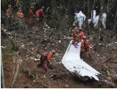  ?? AP ?? Emergency workers search through debris from the China Eastern jet in Tengxian in March