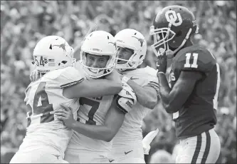  ?? COOPER NEILL/AP PHOTO ?? Texas kicker Cameron Dicker (17) celebrates with teammates after kicking the game-winning field goal in the closing seconds to give the No. 18 Longhorns a wild 48-45 victory over No. 7 Oklahoma on Saturday at the Cotton Bowl in Dallas.