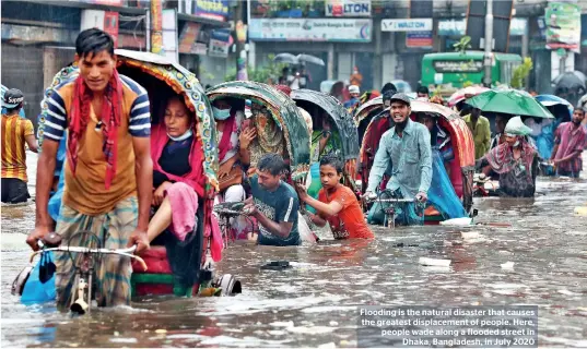  ??  ?? Flooding is the natural disaster that causes the greatest displaceme­nt of people. Here, people wade along a flooded street in Dhaka, Bangladesh, in July 2020