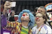  ?? CHRIS O’MEARA / ASSOCIATED PRESS ?? A Ringling Bros. and Barnum & Bailey clown takes a selfie with Jennifer and Kevin Fox, of Fort Pierce, during a preshow event for fans Saturday in Orlando. The Ringling Bros. and Barnum & Bailey Circus will close in May, following a 146-year run.