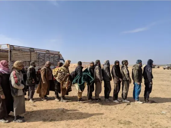  ??  ?? Men who fled Isis-held territory lineup to be questioned (Richard Hall)