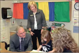  ?? DANIKA TRICE / Staff ?? Georgia State Superinten­dent Richard Woods, left, listens to a student from Tolbert Elementary read while Gordon County Schools Superinten­dent Susan Remillard looks on. Calendar ...................2A Church News.............5A...