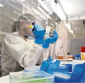  ??  ?? Lab technician extracts DNA for whole genome sequencing at the Colorado Department of Public Health & Environmen­t’s Molecular Science Laboratory.