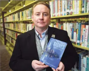  ?? Brian A. Pounds / Hearst Connecticu­t Media ?? Trumbull teacher Daniel Geraghty, seen here at the Trumbull Library on Thursday, published a memoir of his experience as a first responder during the 9/11 World Trade Center attacks titled “Cast Away Stones.”