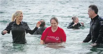  ?? VIA LAW ENFORCEMEN­T TORCH RUN FOR SPECIAL OLYMPICS B.C. ?? Const. Lisa Bruschetta of the Saanich Police Department, left, Victoria athlete Sheenagh Morrison, centre, and others in the water at Willows Beach during the 2022 Vancouver Island Polar Plunge.