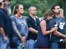  ??  ?? AP PHOTO Friends of Las Vegas shooting victim Denise Burditus of Martinsbur­g, W.Va., attend a vigil in her honor.