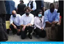  ?? — AFP ?? OTTAWA: Canadian Prime Minister Justin Trudeau (second left) takes a knee during a Black Lives Matter protest on Parliament Hill on Friday.