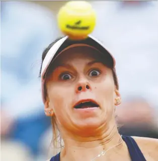  ?? JEAN-FRaNCOIS BADIAS/THE ASSOCIATED PRESS ?? Poland’s Magda Linette has the ball firmly in focus against Romania’s Simona Halep during a second-round match Thursday at the French Open in Paris. Halep won 6-4, 5-7, 6-3.