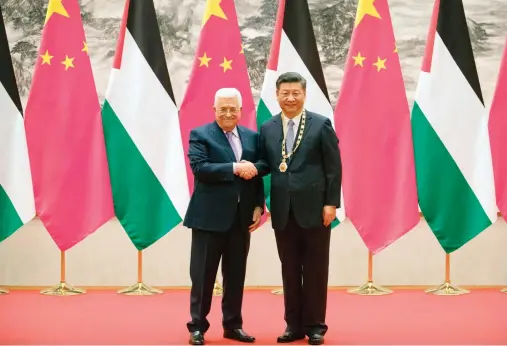  ??  ?? Palestinia­n President Mahmoud Abbas, left, and Chinese President Xi Jinping shake hands during a signing ceremony at the Great Hall of the People in Beijing on Tuesday. (AFP)