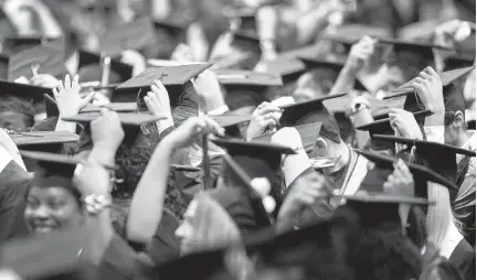  ?? STAFF FILE ?? Graduates of Tidewater Community College move the tassels on their caps during 2017 commenceme­nt exercises in Chartway Arena on the campus of Old Dominion University in Norfolk.