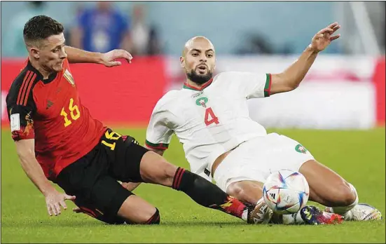  ?? ?? Belgium’s Thorgan Hazard (left), and Morocco’s Sofyan Amrabat challenge for the ball during the World Cup Group F soccer match between Belgium and Morocco, at the Al Thumama Stadium in Doha, Qatar. (AP)
