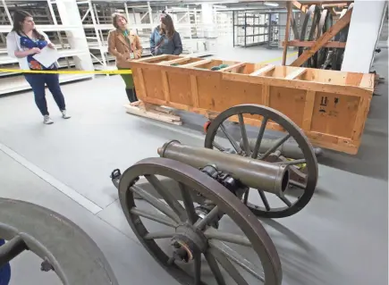  ?? MARK HOFFMAN/MILWAUKEE JOURNAL SENTINEL ?? A cannon on a carriage and a crated cannon barrel are shown at the new State Archive Preservati­on Facility in Madison. A large portion of the collection of the Wisconsin Veterans Museum that is not currently on display is being moved to the the...