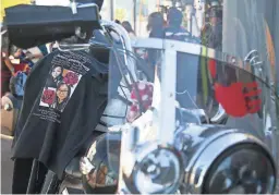  ?? MEG POTTER/THE REPUBLIC ?? A shirt with photos of Jamie Yazzie, an Indigenous woman who went missing in 2019, is laid across Shelly Denny's bike at the Churchill in Phoenix on Saturday before the motorcycle tour kicked off.