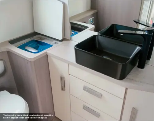  ??  ?? The imposing matte black handbasin and tap add a dash of sophistica­tion to the bathroom space