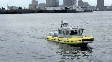  ?? STEVEN SENNE/THE ASSOCIATED PRESS ?? A boat capable of autonomous navigation makes its way around Boston Harbor on Aug. 15. The experiment­al workboat spent this summer dodging tall ships and tankers, outfitted with sensors and self-navigating software and emblazoned with the words...