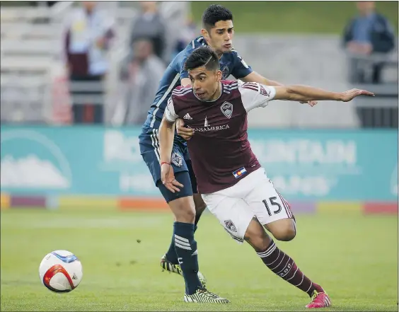  ?? CHRIS HUMPHREYS/USA TODAY SPORTS ?? Colorado Rapids’ Juan Ramirez eludes Whitecaps’ Matias Laba during the first half of Saturday’s game at Dick’s Sporting Goods Park in Denver. The Caps’ 1-0 defeat marked Vancouver’s first back-to-back MLS losses of the season.