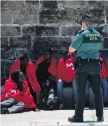  ??  ?? Migrants arrive at the port of Tarifa in southern Spain after being rescued Friday in the Strait of Gibraltar.