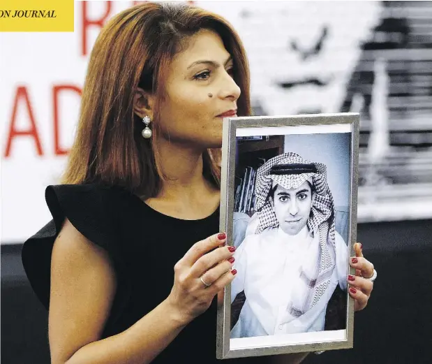  ?? CHRISTIAN LUTZ/AP PHOTO, FILE ?? Ensaf Haidar holds a picture of her husband, jailed Saudi blogger Raif Badawi, whose activist sister is now being detained in Saudi Arabia.