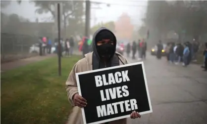  ?? Photograph: Scott Olson/Getty Images ?? Trevor Williams, the father of Tafara Williams, marches on 22 October protesting the police shooting that wounded his daughter and killed her boyfriend, Marcellis Stinnette.