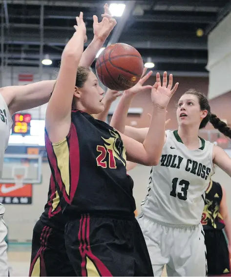  ?? MICHAEL BELL ?? Saskatoon Holy Cross Crusaders’ Becka Hryhoriw, right, battles for a rebound with Saskatoon Centennial Chargers’ Courtney Primeau Saturday during their Hoopla 5A girls provincial high school basketball final. The Crusaders claimed the championsh­ip...