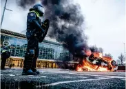  ?? Photo: AFP ?? A car was set alight in front of the train station on Sunday in Eindhoven, the Netherland­s after a rally by several hundreds of people against the coronaviru­s policy.