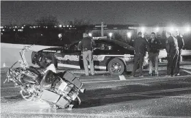  ?? Stetson Payne / Tulsa World via Associated Press ?? Emergency personnel respond to a crash involving multiple vehicles and a police officer who was on foot in Catoosa, Okla., on Wednesday during a winter storm.