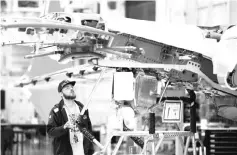  ??  ?? A Boeing worker is pictured in the wing system installati­on area at their factory in Renton, Washington. Now sales of jetliner services have been brought under the same umbrella as plane sales, headed by senior vice president Ihssane Mounir, Boeing...