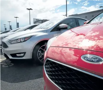  ?? GETTY IMAGES FILES ?? Ford Focus compact cars are offered for sale at a dealership in Chicago, Ill.