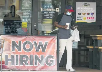  ?? LM OTERO — THE ASSOCIATED PRESS FILE ?? A customer walks past a now hiring sign at an eatery in Richardson, Texas, earlier this week. The Labor Department reported unemployme­nt numbers Thursday, Sept. 3.