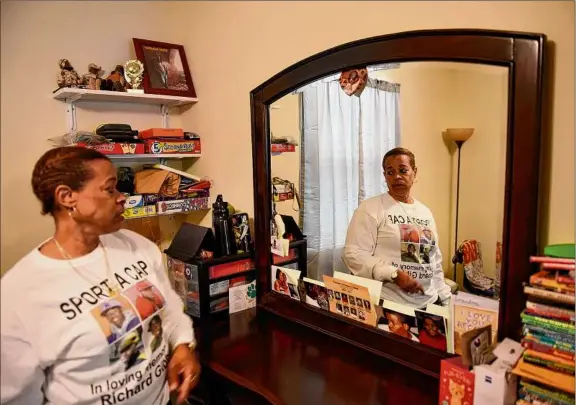  ?? Photos by Will Waldron / Times Union ?? Roslyn Stevens often tells her grandson, Mhy-shawn, “if you weren’t just like your daddy.” To keep the memory of his father, ‘Shaddi’ Gibbs, present in his life, she has filled his room with photos and keepsakes of his father, who died at 25 when his son, now 10, was an infant.