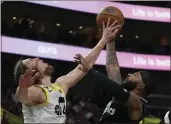  ?? RICK BOWMER — THE ASSOCIATED PRESS ?? Utah forward Kelly Olynyk, left, rejects a shot by Clippers forward Marcus Morris Sr. during the second half.