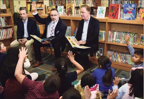  ?? Erik Trautmann / Hearst Connecticu­t Media ?? From left, state Senate Majority Leader Bob Duff, state Department of Education Commission­er Miguel Cardona and Gov. Ned Lamont visit Silvermine Dual Language Magnet School on Feb. 28, 2020, to read to students in recognitio­n of Read Across America at the school in Norwalk. Cardona is President-elect Joe Biden’s pick for U.S. secretary of education.